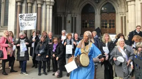 PA Campaigners celebrate outside the Royal Courts of Justice in central London