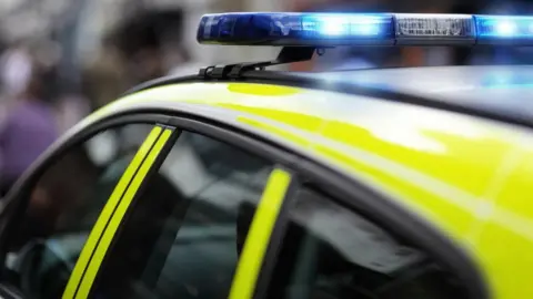 Getty Images A police car with blue lights flashing