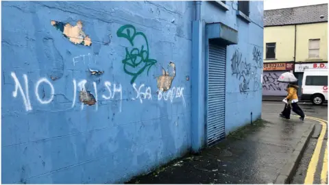 PA Media Graffiti in Belfast with the words ' No Irish Sea border' written