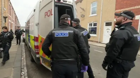 BBC Officers with police van doors open