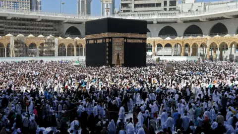 Getty Images Muslim pilgrims walk around the Kaaba (Tawaf al-Wadaa), Islam's holiest shrine, at the Grand Mosque in Saudi Arabia's holy city of Mecca on February 27, 2020