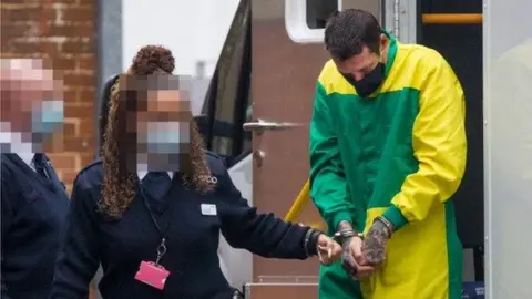 EDDIE MITCHELL Mark Brown in handcuffs ahead of a previous court appearance