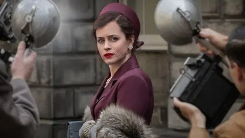 BBC / Blueprint Productions A picture of actress Claire Foy surrounded by photographers in A Very British Scandal