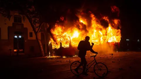 AFP A bus burns down in downtown Santiago