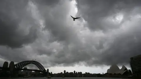 AFP Storm clouds gather over Sydney Harbour on January 20