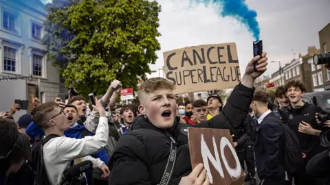 Getty Images Fans of Chelsea Football Club protest against the European Super League outside Stamford Bridge on April 20, 2021 in London, England.