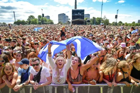 Getty Images fans watch the sundara Karma on the main stage on Saturday