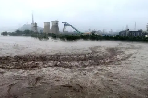 AFP This picture shows a view of the overflooded Yongding River following heavy rains in Beijing on August 1, 2023.