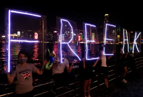 Reuters Anti-government protesters hold Pepe the Frog plush toys as they make a human chain in the harbour area in Hong Kong, China, September 30, 2019.