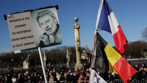 AFP Poster reads: "Goodbye to you, Johnny, you will stay in our lives for ever"