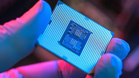 Getty Images Person holding a computer chip.