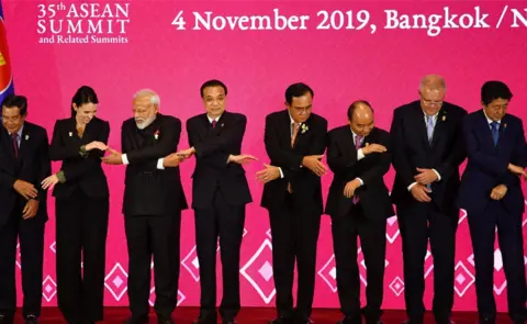 Getty Images (From L to R) Cambodia's Prime Minister Hun Sen, New Zealand's Prime Minister Jacinda Ardern, India's Prime Minister Narendra Modi, China's Premier Li Keqiang, Thailand's Prime Minister Prayut Chan-O-Cha, Vietnam's Prime Minister Nguyen Xuan Phuc, Australia's Prime Minister Scott Morrison and Japan's Prime Minister Shinzo Abe prepare to pose for a group photo during the 3rd Regional Comprehensive Economic Partnership (RCEP) Summit in Bangkok in November 2019