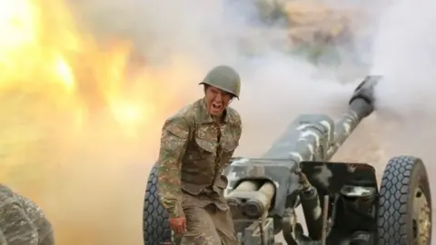 Reuters An ethnic Armenian soldier fires an artillery piece in Nagorno-Karabakh. Photo: 29 September 2020