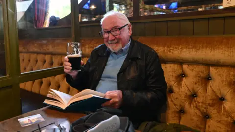 Pacemaker Man with book and a beer