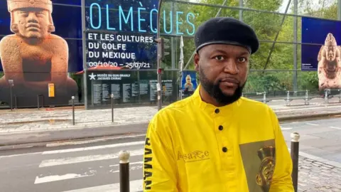 Reuters Emery Mwazulu Diyabanza in front of the Quai Branly museum in Paris on 2 October 2020