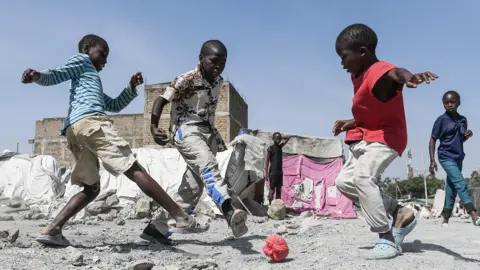 AFP Children playing football in Nairobi, Kenya - Thursday 10 March 2022