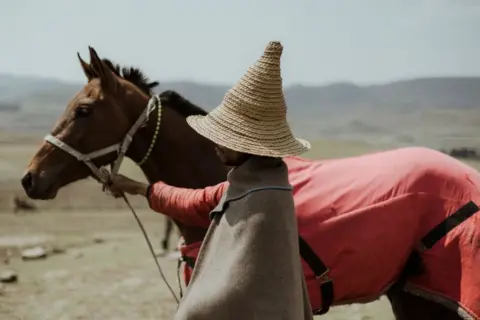 AFP A man in a hat and a horse