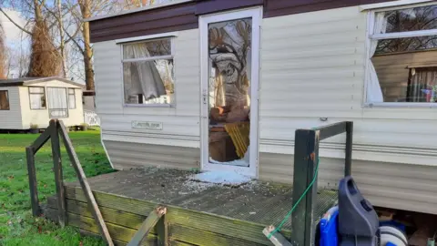 Smashed glass door of caravan