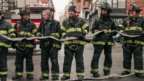Getty Images Firefighters at the scene of a apartment block fire in New York