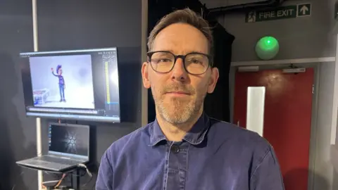 Mark Hewis standing in one of the animation studios