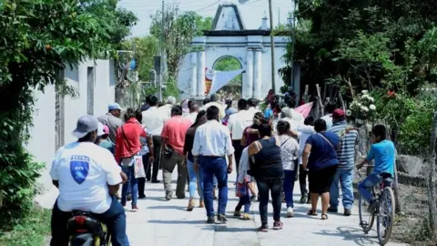 EPA Inhabitants of the Telixtac indigenous community move the remains of a person who died after ingesting allegedly adulterated alcohol, in the municipality of Axochiapan in the state of Morelos, Mexico, 12 May 2020