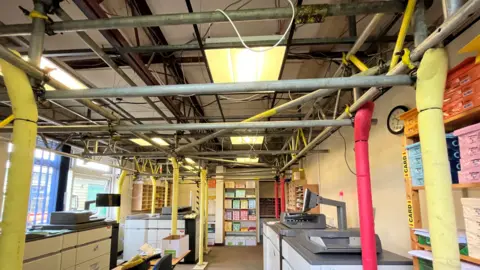 Shaun Whitmore/BBC Props are being used to support the roof in an office space