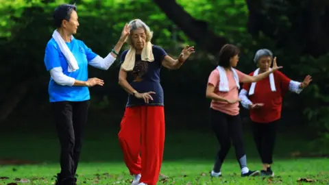 Getty Images People exercise at a park on 10 April 2021 in Singapore