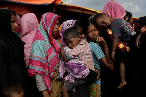 Reuters Rohingya refugees line up for a food supply distribution at the Kutupalong refugee camp near Cox's Bazar, Bangladesh 12 December 2017.