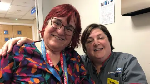 Emma Baugh/BBC Caroline Coster with nurse Cathy O'Brien inside Bedford Hospital