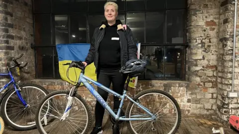 Swindon Welcomes Ukraine Woman standing with bike