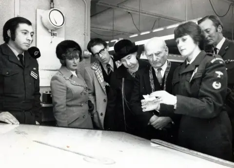 Lee Karen Stow Ann Metcalfe in the 1960s demonstrating her role to visiting dignitaries at York Cold War bunker