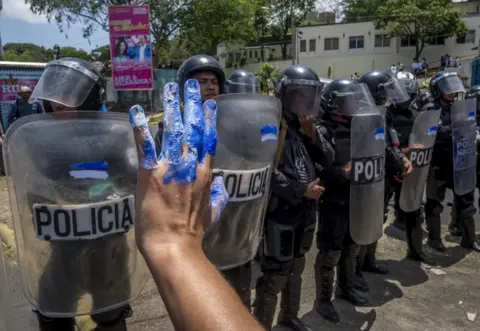 Javier Bauluz Nicaraguan women protest in front of riot police during a demonstration in Managua on 2 May 2018