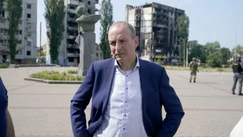 PA/ Niall Carson Taoiseach Michael Martin viewing the damage to the Borodyanka area