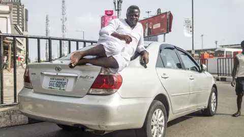 AFP A may lying on his car on Lagos Island, Lagos, Nigeria - Monday 27 February 2023