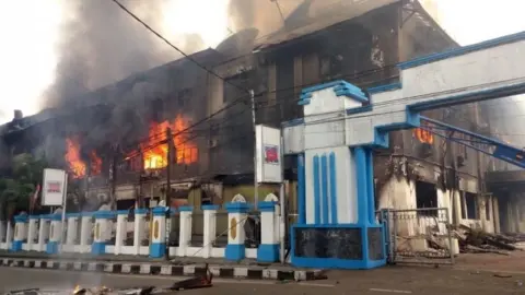 EPA A local parliament building burns during a protest in Manokwari, West Papua, Indonesia