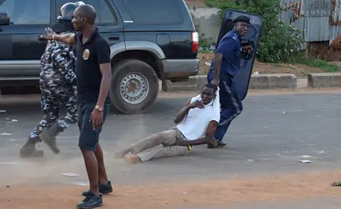 Reuters Anti riot policeman drags away a supporter of Sierra Leone People"s Party (SLPP) during a protest against the police attempting to search the offices of Julius Maada Bio, the presidential candidate for (SLPP) in Freetown, Sierra Leone March 7, 2018.