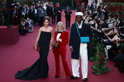 Getty Images Singer Rita Ora, Twiggy and Wisdom Kaye pose for a photo as they attend Vogue World