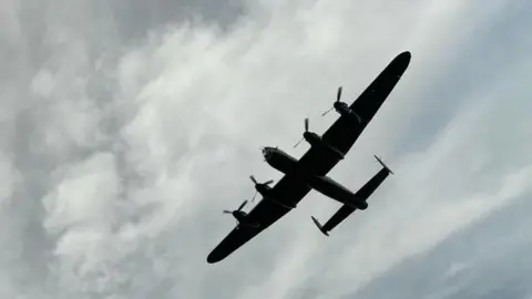 BBC Lancaster bomber flying above in the sky