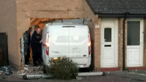 SWNS Van crashed into house