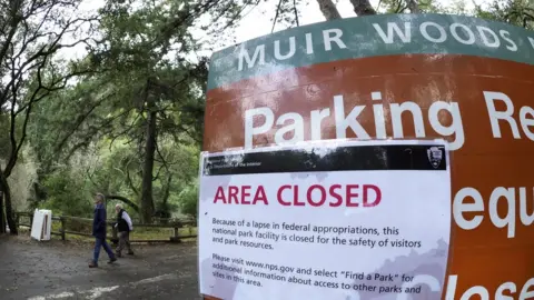 EPA Hikers walk out of a closed Muir Woods National Monument, part of California's Golden Gate National Recreation Area,