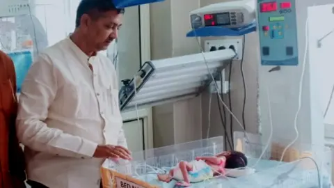 Anoop Kumar Mishra Local politician Rajesh Kumar Mishra with the baby in hospital