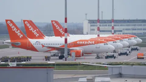 Getty Images Passenger planes of discount airline EasyJet stand on the tarmac at Berlin-Schoenefeld Airport.