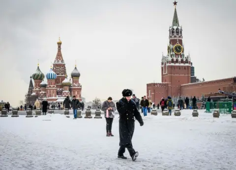 Getty Images A serviceman walks in front of St Basil's Cathedral and the Kremlin