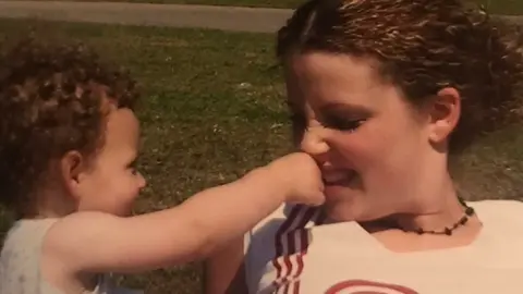 Laura Worthington Laura with one of her children pinching her nose