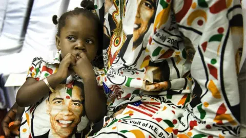 AFP Two-year-old Princess Smith sits with her father Francis Smith on July 11, 2009 as they wait for US President Barack Obama's arrival at the International Conference Center in Accra, Ghana, where he is to address members of the parliament.