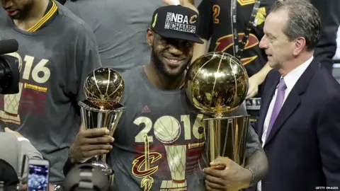 Getty Images Lebron James holding two trophies
