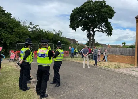 Stephen Huntley/BBC Police and protesters near the oak tree