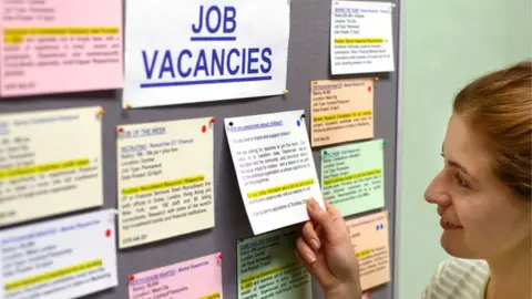 Getty Images Woman looking at job vacancies