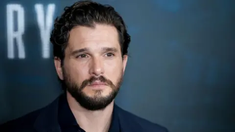 Kit Harrington appears on the red carpet for a premier 