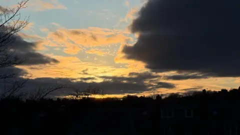 Sunshine through the clouds above Aberdeen in silhoutte
